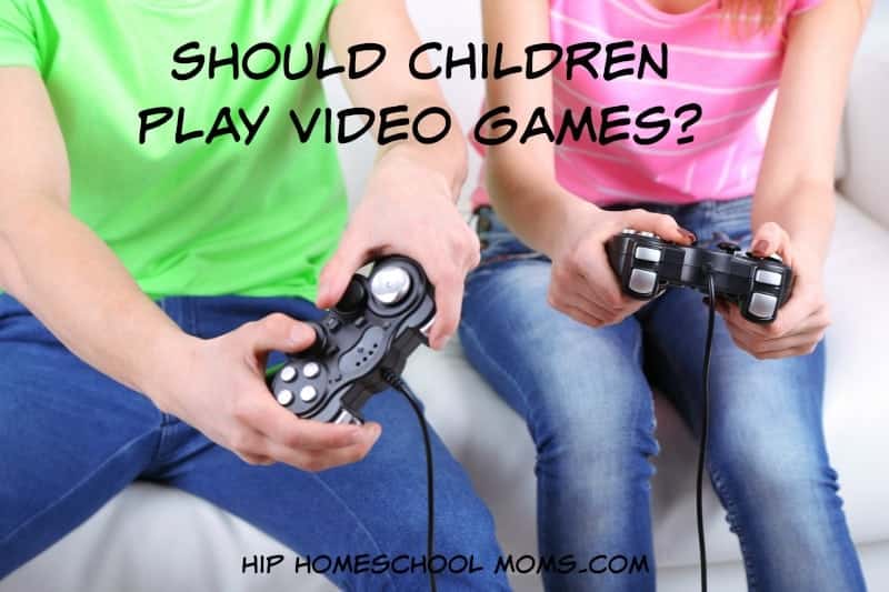 Girl and boy playing video games at home