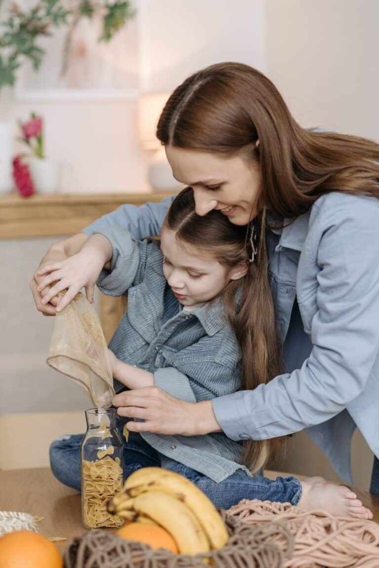 fine motor skills girl and mother pouring into a jar