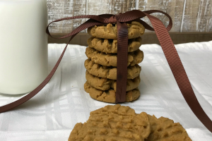 Flourless Peanut Butter Cookies Recipe a stack of cookies tied with a brown bow on a white tablecloth