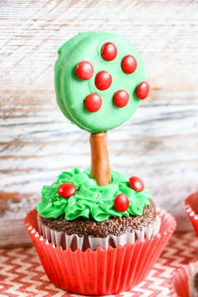cupcake with an apple tree made of green dipped oreos and red m & m