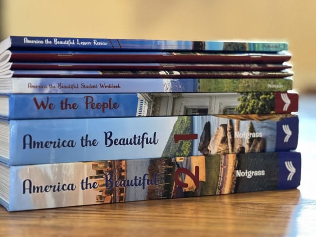 Notgrass History America the Beautiful - book stack of America the Beautiful part one and two, We the People, the Student Workbook, Lesson Review, etc.