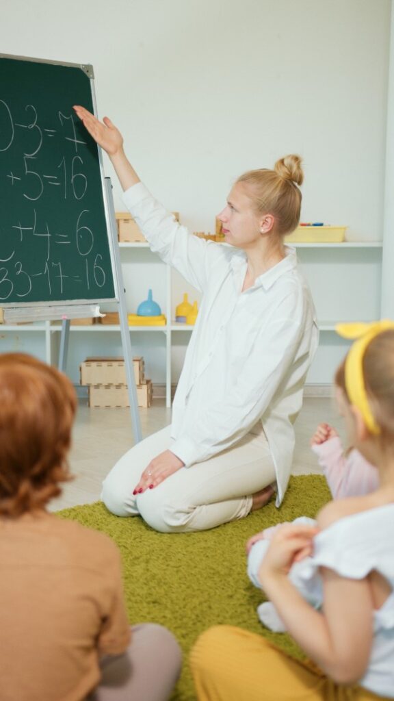 why math matters - young woman teaching children math on a blackboard