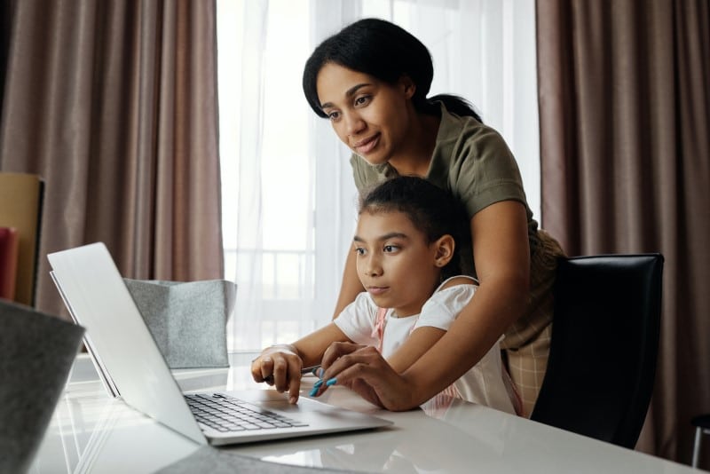 homeschooling middle school - mother and tween daughter in front of laptop